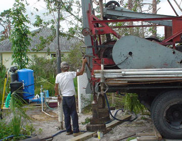 well guy with truck pulling old-well-out